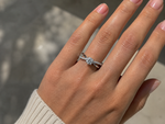 Load image into Gallery viewer, Round lab grown diamond X-shank engagement ring worn on hand in white gold with pavé band