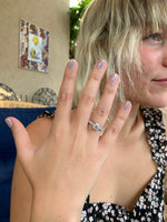 Load image into Gallery viewer, Lifestyle image of a white gold lab-grown round diamond engagement ring showing fit and scale