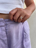 Load image into Gallery viewer, Emerald cut solitaire lab-grown diamond ring in yellow gold worn on hand