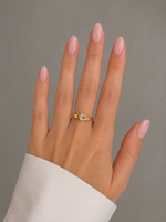 Load image into Gallery viewer, Close-up view of the Different Love natural diamond ring in yellow gold worn on a woman’s hand.