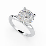 Load image into Gallery viewer, a white gold engagement ring with a round cut diamond