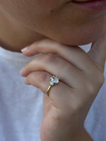 Load image into Gallery viewer, Three-stone oval diamond engagement ring on hand with natural oval diamonds