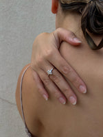 Load image into Gallery viewer, Fifty Fifty natural pear shape diamond ring worn on hand, pear cut diamond with half bezel half prong setting