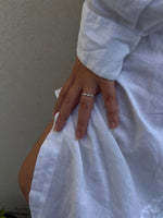 Load image into Gallery viewer, East-West marquise natural diamond half eternity ring in white gold worn on hand with a white dress