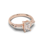 Load image into Gallery viewer, Rose gold emerald cut lab-grown diamond ring shown from an angled front perspective with tapered side stones