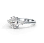 Load image into Gallery viewer, oval cut diamond three stone ring with pear side diamonds angled view