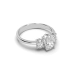 Load image into Gallery viewer, Side view of three-stone oval-cut diamond engagement ring showing oval side stones