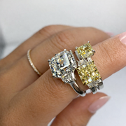 Three natural diamond rings worn on hand, showcasing a white Asscher cut diamond alongside fancy light yellow radiant cut diamonds, complemented by trapezoid side stones.