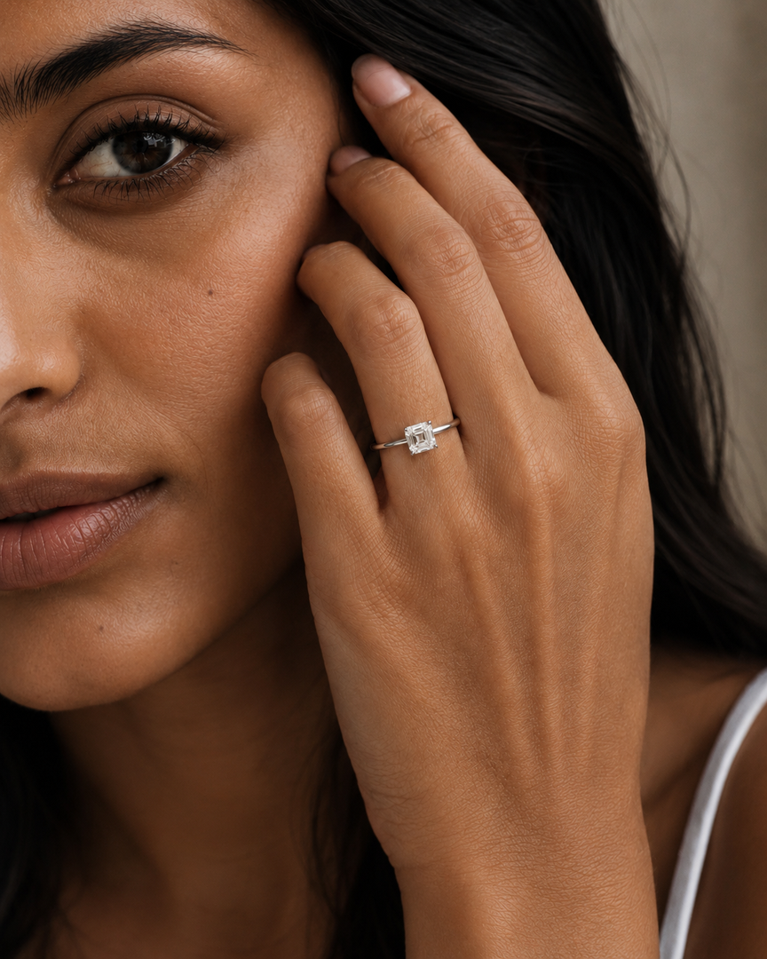 Asscher cut solitaire lab-grown diamond ring in rose gold, shown from front and side views and worn on a woman’s hand.