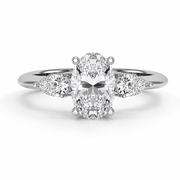     White gold three stone oval natural diamond ring with pear side diamonds, front view showcasing the oval center diamond