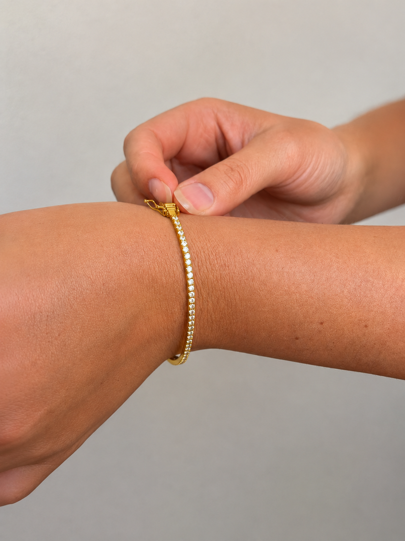 Woman Wearing a Solid Lab Grown Diamond Bangle Bracelet in Yellow Gold with Round Diamonds, Slim Rigid Design, Lifestyle Close-Up on Wrist