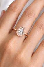 Load image into Gallery viewer, Pear Halo Biza natural diamond engagement ring in rose gold with halo setting, worn on hand