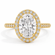     Oval halo natural diamond ring in yellow gold, front view on a white background.