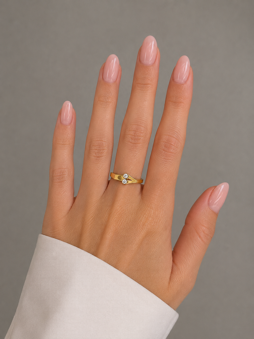 Close-up view of the Different Love natural diamond ring in yellow gold worn on a woman’s hand.