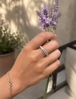Load image into Gallery viewer, Seven stone round natural diamond half eternity band shown on a woman’s hand in a natural lifestyle setting.