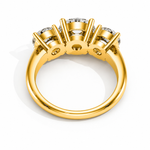 Load image into Gallery viewer, Underside view of a three stone round natural diamond engagement ring in yellow gold highlighting the open gallery design.