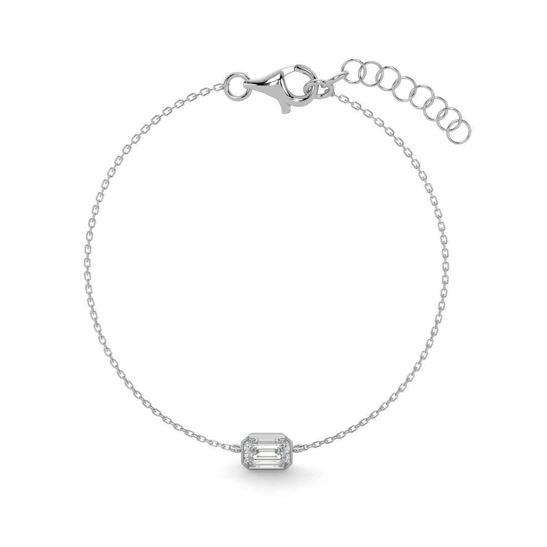     Emerald-cut natural diamond bezel bracelet in white gold on a white background.