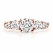 Rose gold five-stone ring with graduated round brilliant natural diamonds, photographed from the front on a clean white background.