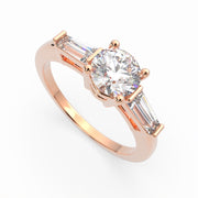 a rose gold engagement ring with three baguets