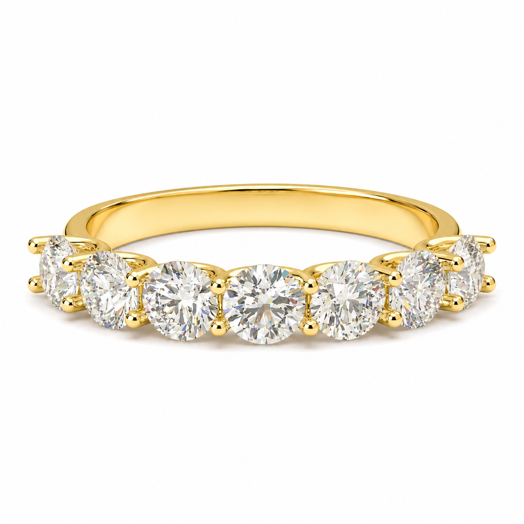 Front view of a seven stone round lab-grown diamond half eternity band in yellow gold on a white background.