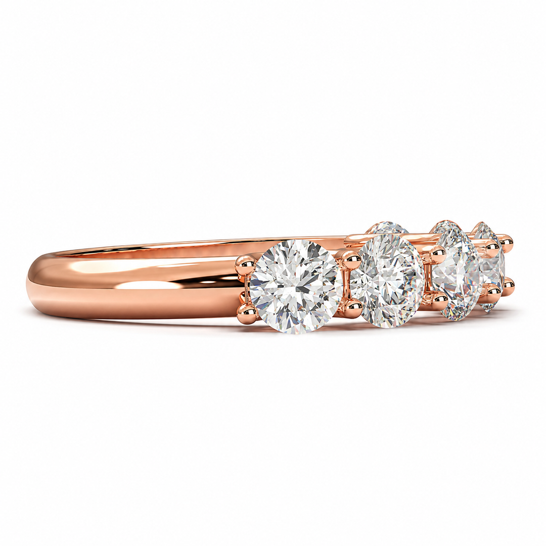 Side view of a seven stone round lab-grown diamond half eternity band in rose gold on a white background.