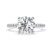 a diamond engagement ring with a side stones