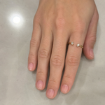 Load image into Gallery viewer, Woman wearing an open pear-cut natural diamond ring on her finger.