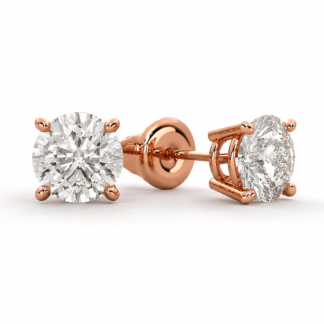Lab-grown round diamond stud earrings in polished 14K rose gold with secure four-prong settings.