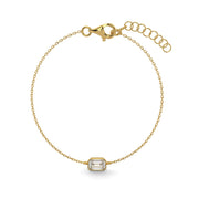     Emerald-cut natural diamond bezel bracelet in yellow gold on a white background.