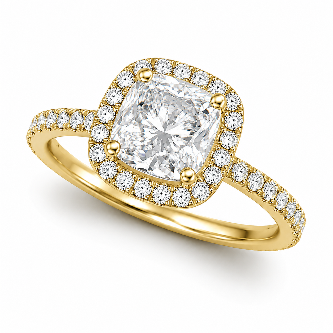     Cushion halo natural diamond ring in yellow gold, three-quarter view on a white background.