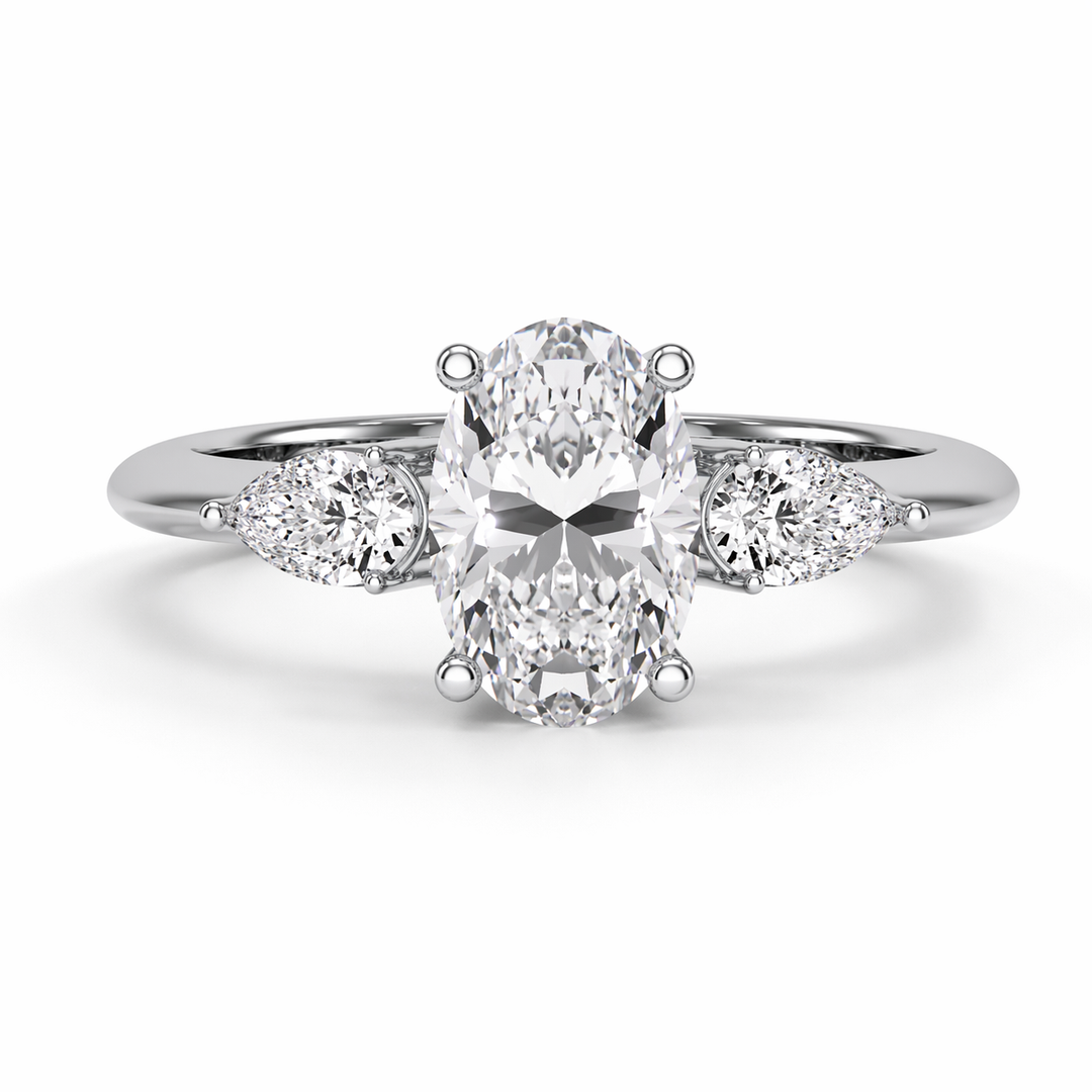     White gold lab-grown oval three stone diamond ring with pear side diamonds, front view featuring the oval center stone