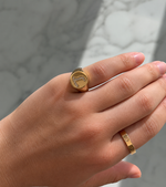 Load image into Gallery viewer, Natural diamond initial signet ring in yellow gold, round-cut diamonds, letter L detail, shown on hand against a soft neutral background