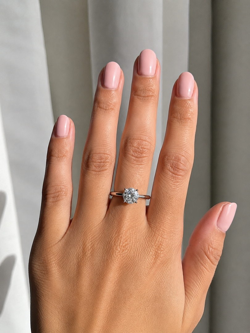 On-hand view of yellow gold solitaire engagement ring with lab-grown round brilliant diamond