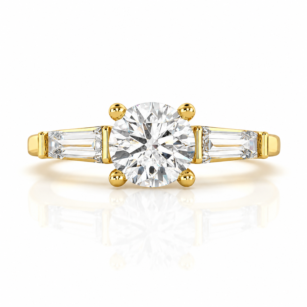 Three stone round lab grown diamond engagement ring with tapered side stones in yellow gold, front view