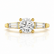 Three stone round lab grown diamond engagement ring with tapered side stones in yellow gold, front view