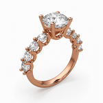 Load image into Gallery viewer, Ericiera round lab-grown diamond ring in 18K rose gold with a round brilliant center diamond and diamond accent band, angled view.