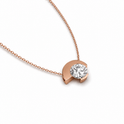 Asymmetric round natural diamond necklace in rose gold, clean contemporary look, angled view
