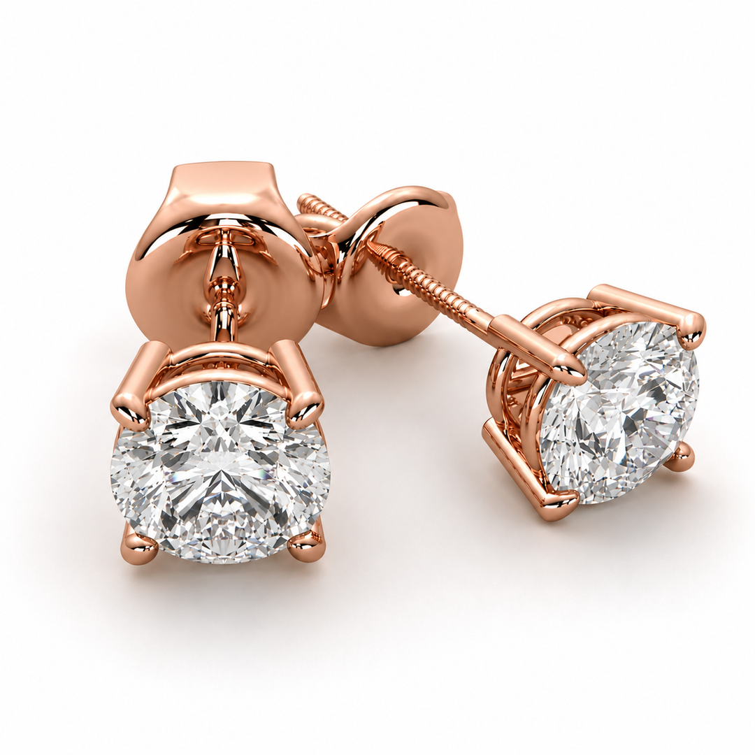 Natural round diamond stud earrings in 14K rose gold with a classic four-prong solitaire setting.