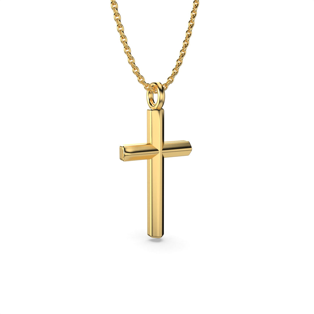 Gold cross necklace on a chain shown at a slight angle