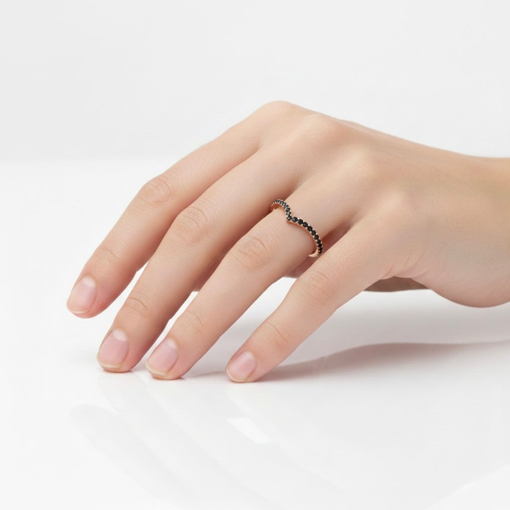 Black diamond V-shaped ring worn on hand, minimalist chevron wedding band with pavé black diamonds
