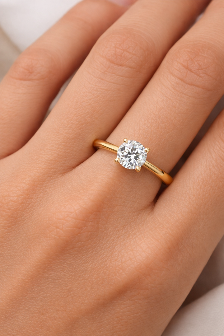 On-hand view of yellow gold solitaire engagement ring with lab-grown round brilliant diamond