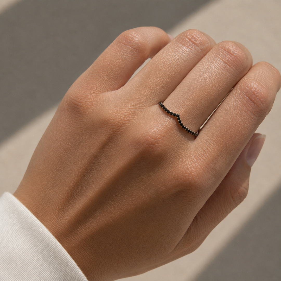 Black diamond V-shaped ring worn on hand, minimalist chevron wedding band with pavé black diamonds
