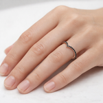 Load image into Gallery viewer, Black diamond V-shaped ring worn on hand, minimalist chevron wedding band with pavé black diamonds
