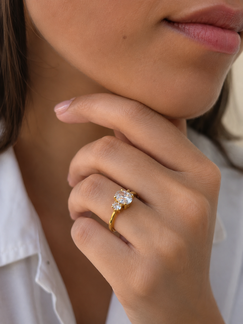 Oval Three-Stone Lab-Grown Diamond Ring Oval Sides in Yellow Gold Worn on Hand Close-Up