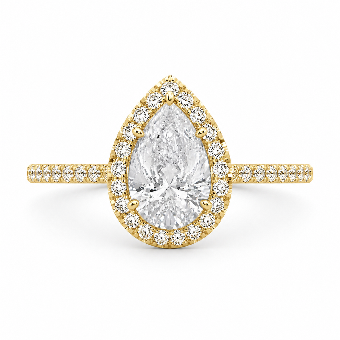 Lab-grown pear halo diamond ring in 14K yellow gold with a pear-shaped center diamond and sparkling halo.