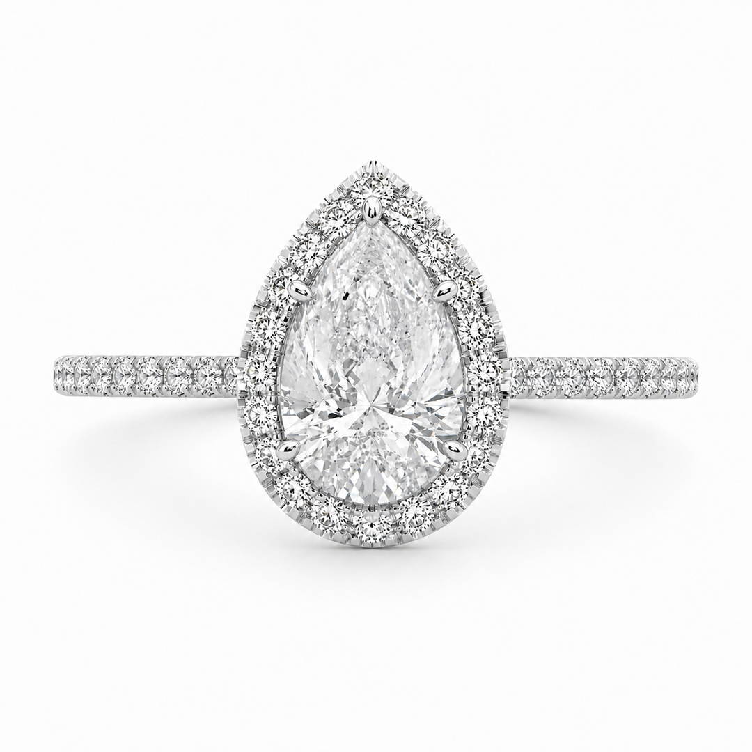 Natural pear halo diamond ring in 14K white gold featuring a pear-shaped center diamond surrounded by a halo of natural diamonds.