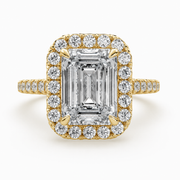     Front view of a lab-grown emerald-cut diamond halo ring in yellow gold with pavé side diamonds