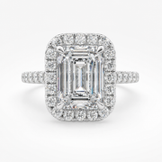 Natural emerald-cut diamond halo ring in white gold, front view, with round diamond halo and pavé side diamonds