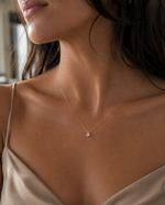 Load image into Gallery viewer, Woman wearing a rose gold pear-cut lab-grown diamond pendant necklace, displayed at the center of the neckline
