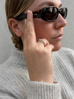 Load image into Gallery viewer, Seven stone round natural diamond half eternity band worn by a woman wearing sunglasses.